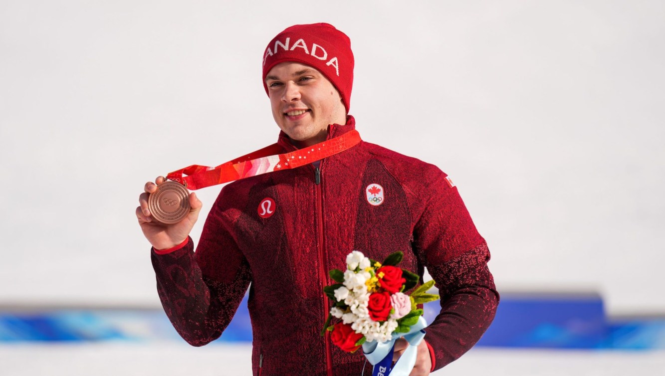 Jack Crawford shows off his bronze medal on the podium