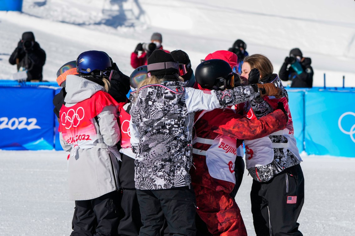 Snowboarders in a group hug