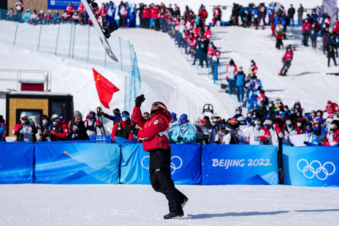 Mark McMorris tosses his snowboard in the air in celebration