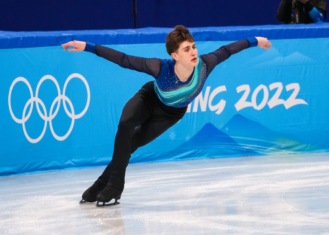 Roman Sadovsky skates with his arms out