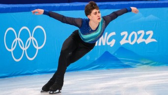 Roman Sadovsky skates with his arms out