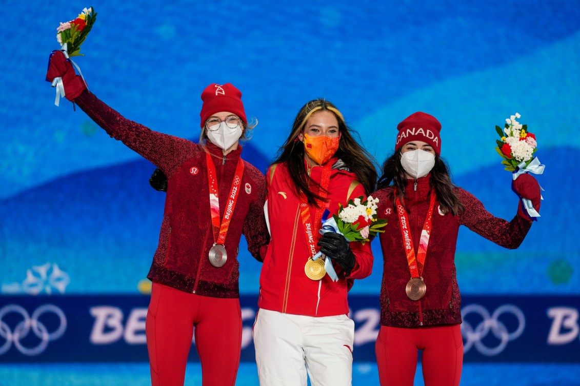 Cassie Sharpe and Rachael Karker stand on the podium with Eileen Gu