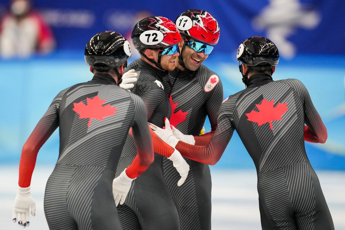 Canadian short track speed skaters celebrate after a relay