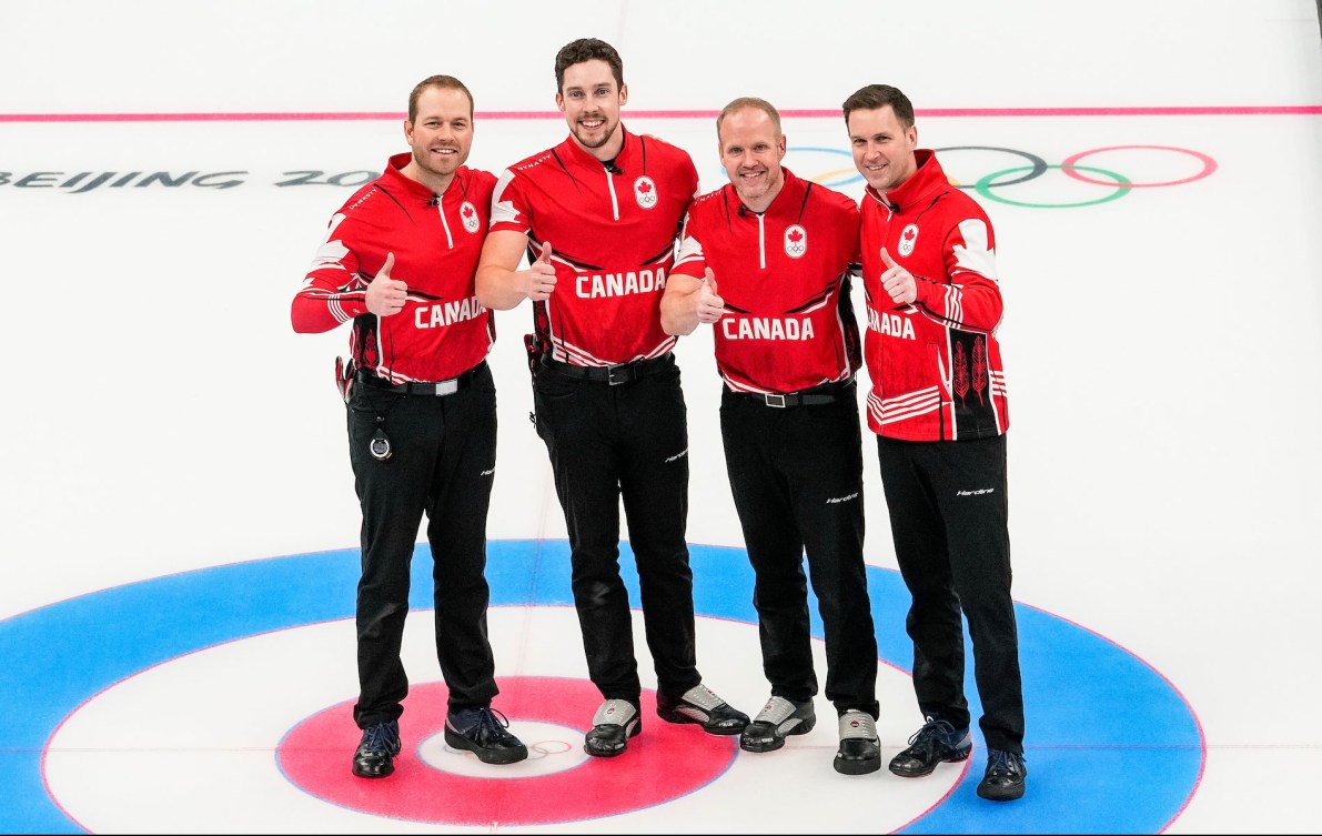 Team Gushue pose with a thumbs up after winning the bronze medal