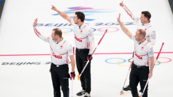 The four members of Team Gushue wave to the crowd