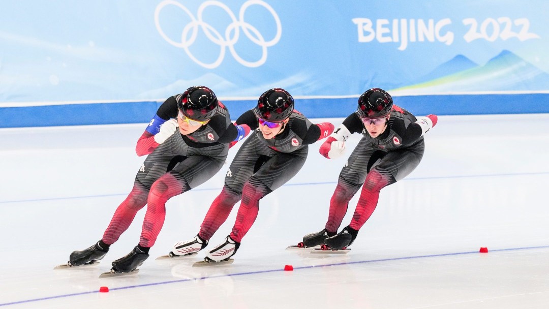 Women's long track speed skaters skating in team pursuit