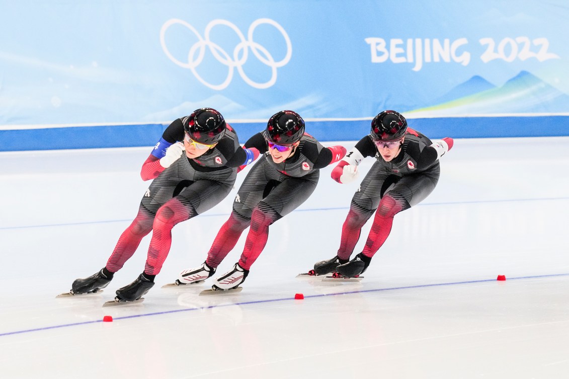 Isabelle Weidemann, Ivanie Blondin and Valerie Maltais skate in a row in the team pursuit 