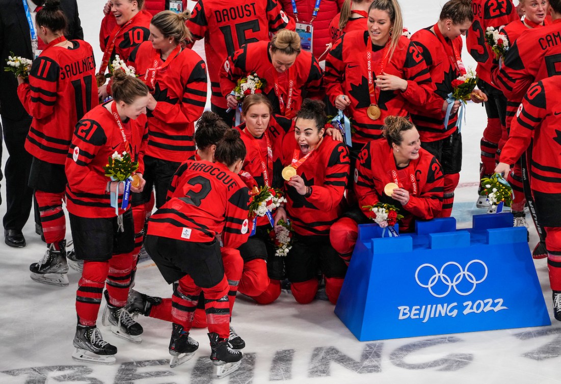 Team Canada celebrates winning the gold medal women's hockey game