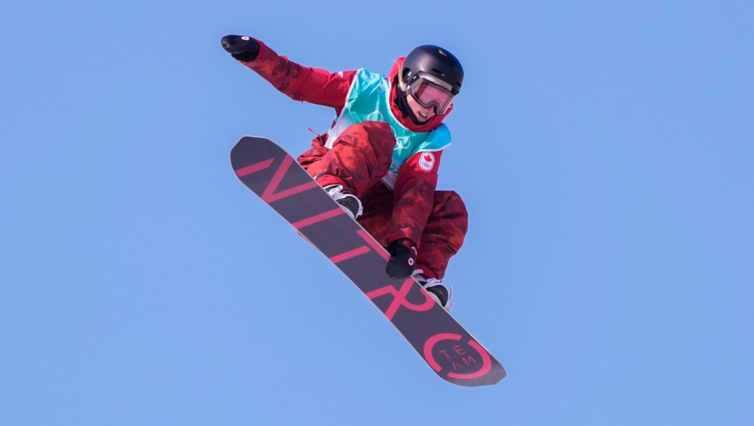 A member of Team Canada flies through the air during a slopestyle snowboard run