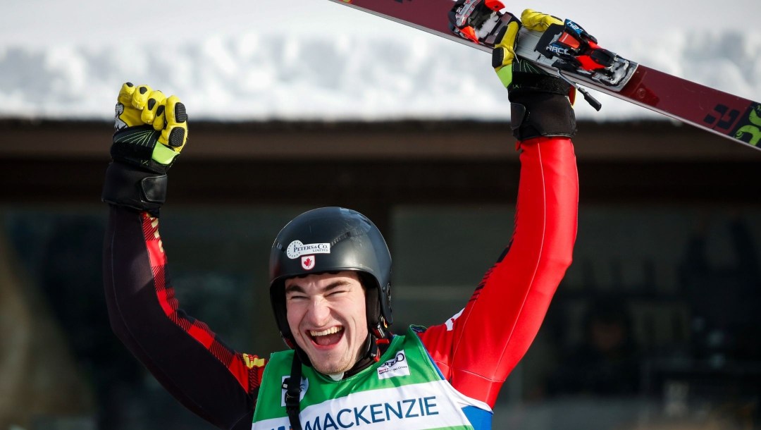 A member of Team Canada celebrates with his hands in the air after completing a World Cup run
