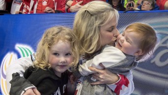 Canada skip Jennifer Jones hugs her children Isabella (left) and Skyla (right) after beating Sweden in the gold medal game at the World Women's Curling Championship Sunday, March 25, 2018 in North Bay, Ont.