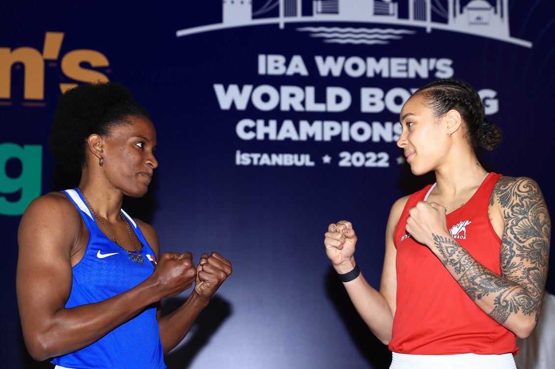 Tammara Thibeault and her opponent face each other after their weighin