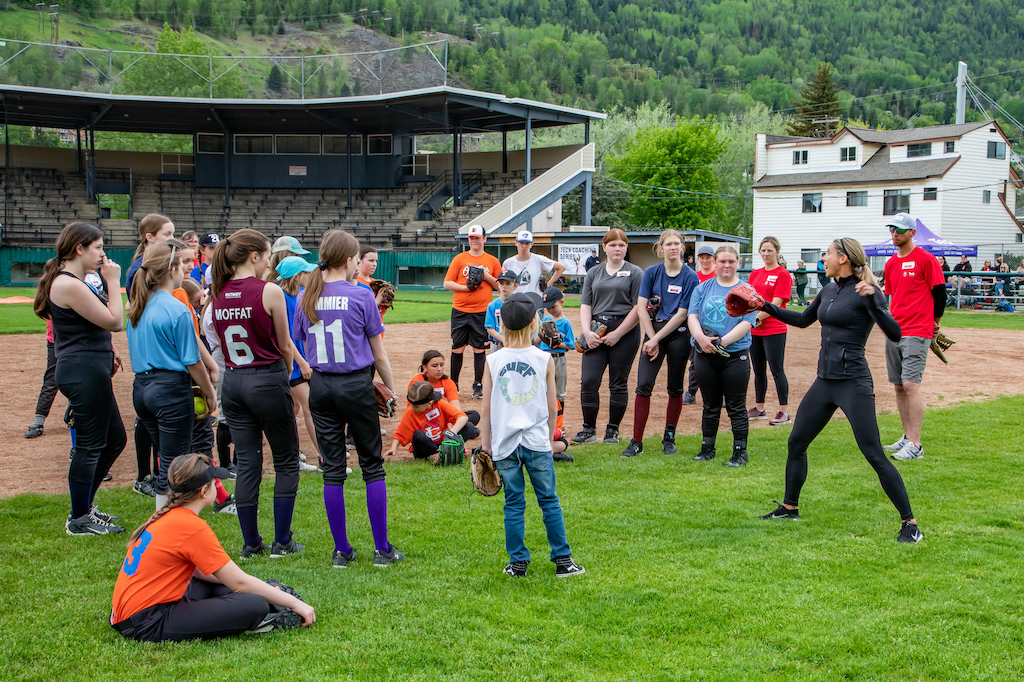 Lauren Regula shows young softball players her pitching technique