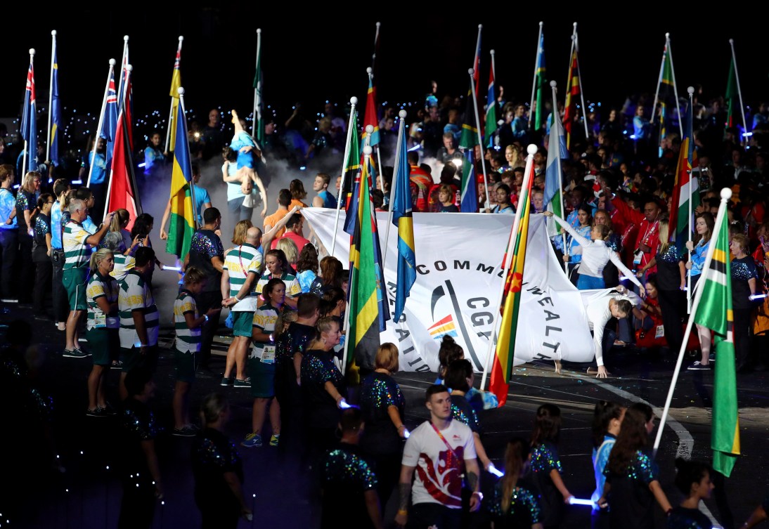 The Commonwealth Games flag is carried amongst the flags of many nations 