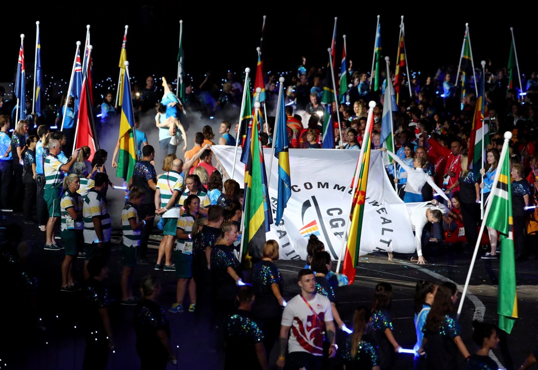 The Commonwealth Games flag is carried amongst the flags of many nations