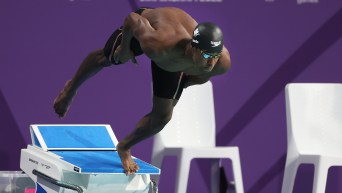 Joshua Liendo dives from the start blocks of the swimming pool