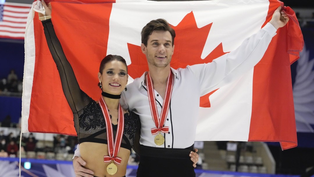 Laurence Fournier Beaudry and Nikolaj Soerensen of Canada pose for a photo celebrating their winning gold in the ice dance free dance program in the Grand Prix of Figure Skating - NHK Trophy in Sapporo, Japan, Saturday, Nov. 19, 2022. (AP Photo/Hiro Komae)