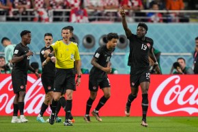Alphonso Davies and teammates celebrate a goal