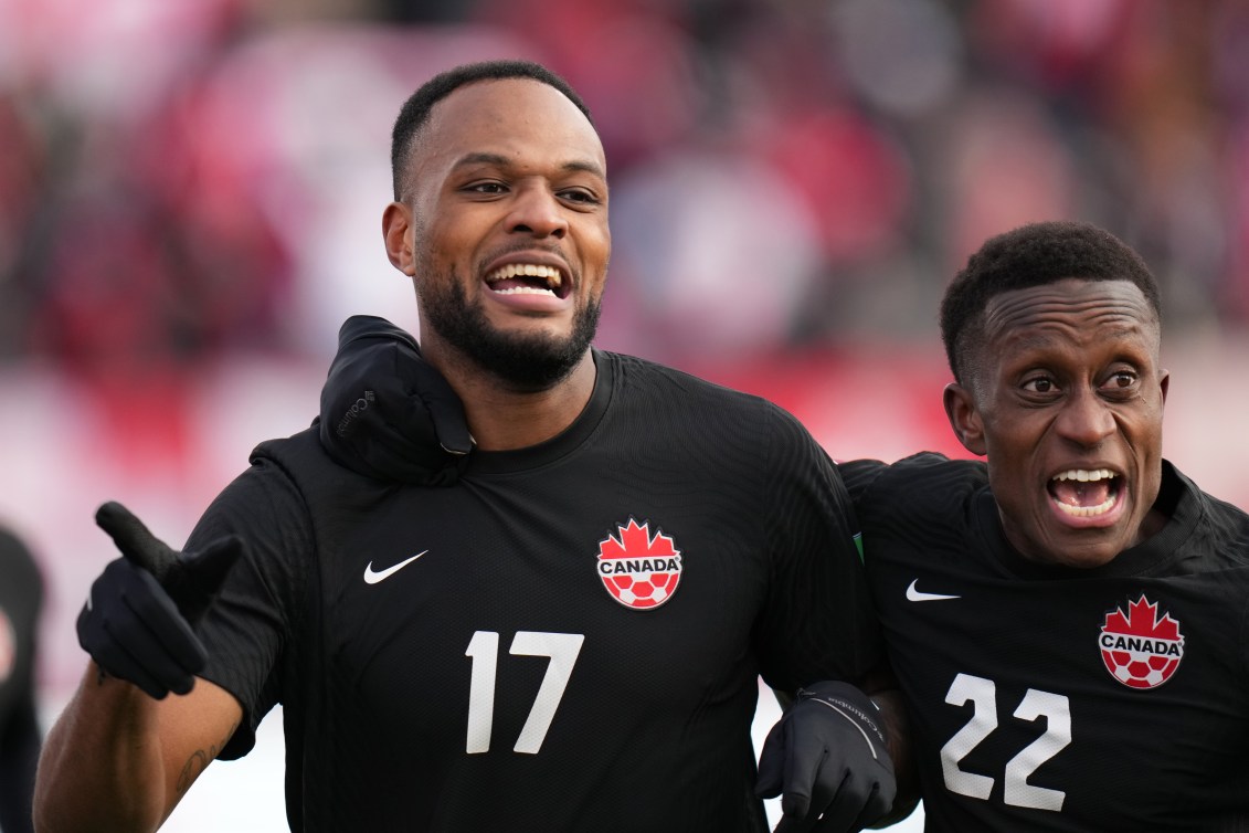 Cyle Larin and Richie Laryea celebrate a goal