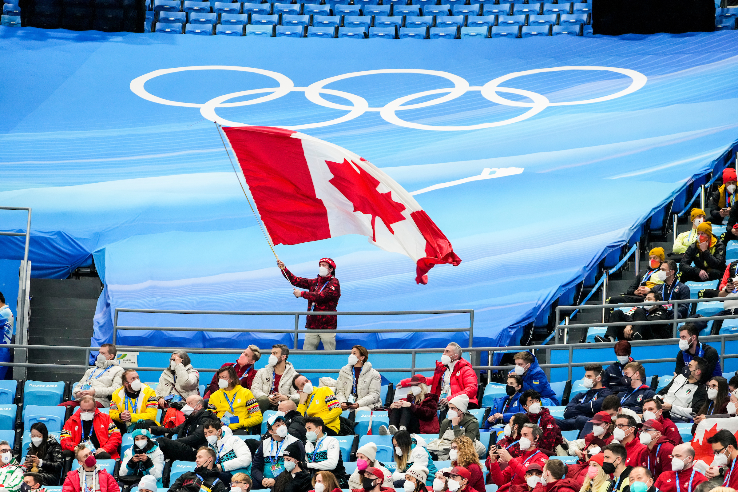 Keegan Messing waves a giant Canadian flag in the stands
