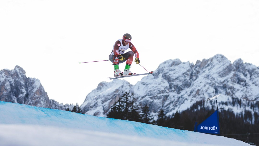 Reece Howden flies through the air during a ski cross race