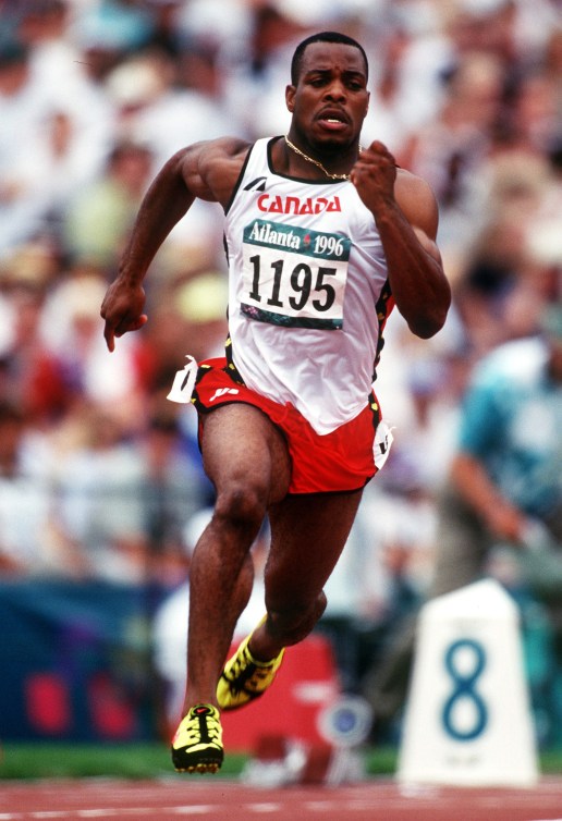 Carlton Chambers running on a track in a race