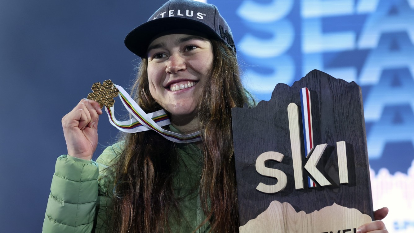 Laurence St Germain holds up her gold medal and world champion trophy