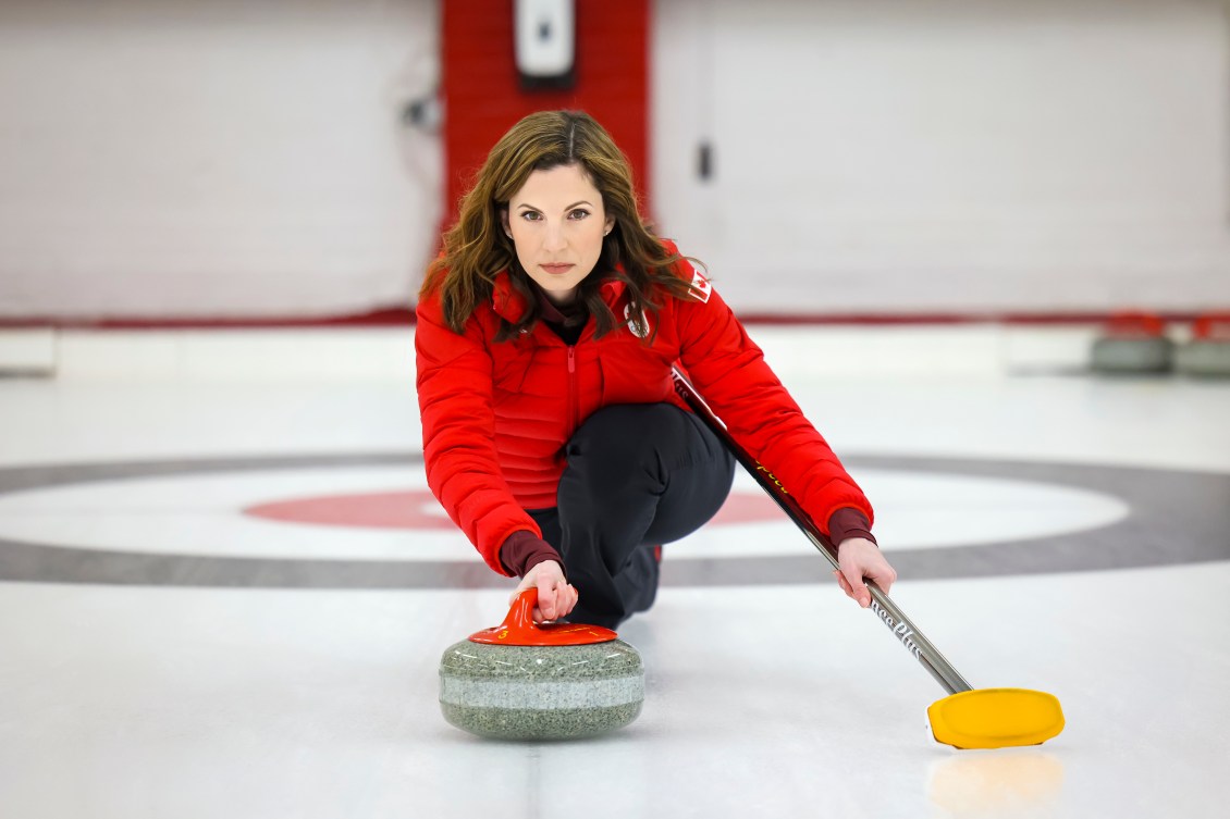 Lisa Weagle slides towards the camera as she prepares to throw a curling stone 