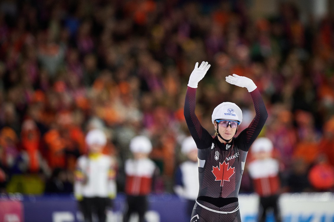 Ivanie Blondin waves both arms above her head while being introduced before a race 
