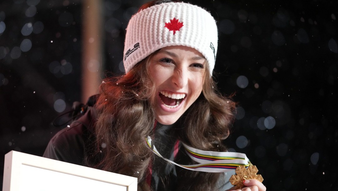 Alexandria Loutitt grins widely while wearing a gold medal around her neck