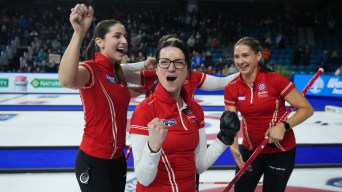 Kerri Einarson and her teammates pump their fists in celebration after a win