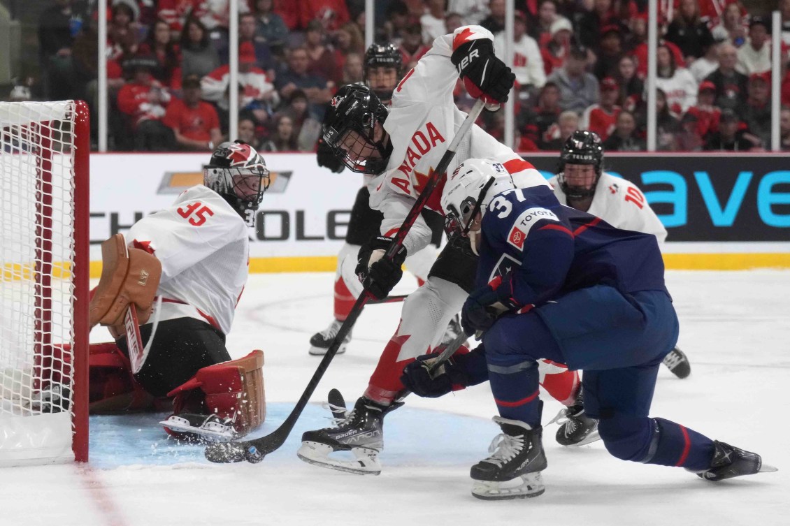Team Canada's Renata Fast battles for the puck against the United States during the gold medal game of the 2023 IIHF Women's Hockey Championship.