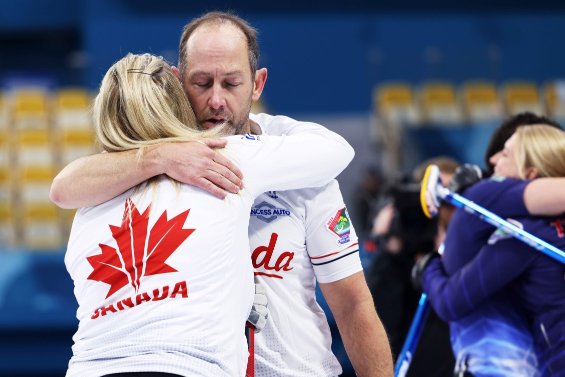 Brent Laing and Jennifer Jones hug after a loss