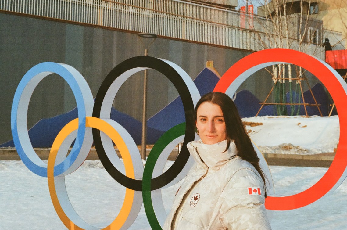 JJ Hawkrigg poses in front of the Olympic rings 