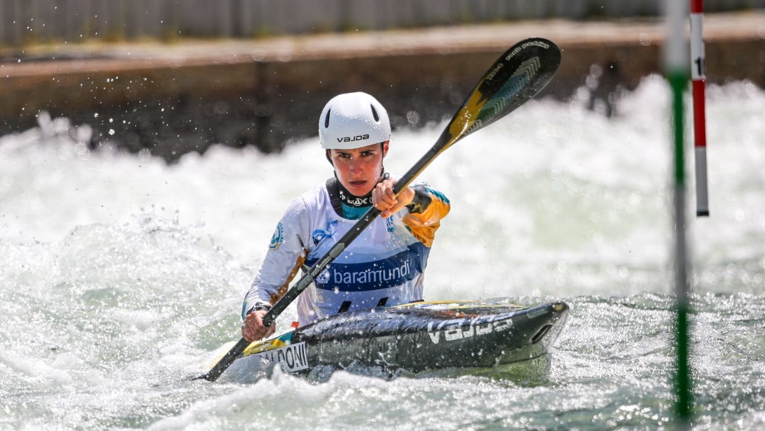 Lea Baldoni paddles her kayak through a whitewater slalom course