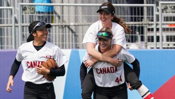 Rylie Crane gives her teammate a piggy back