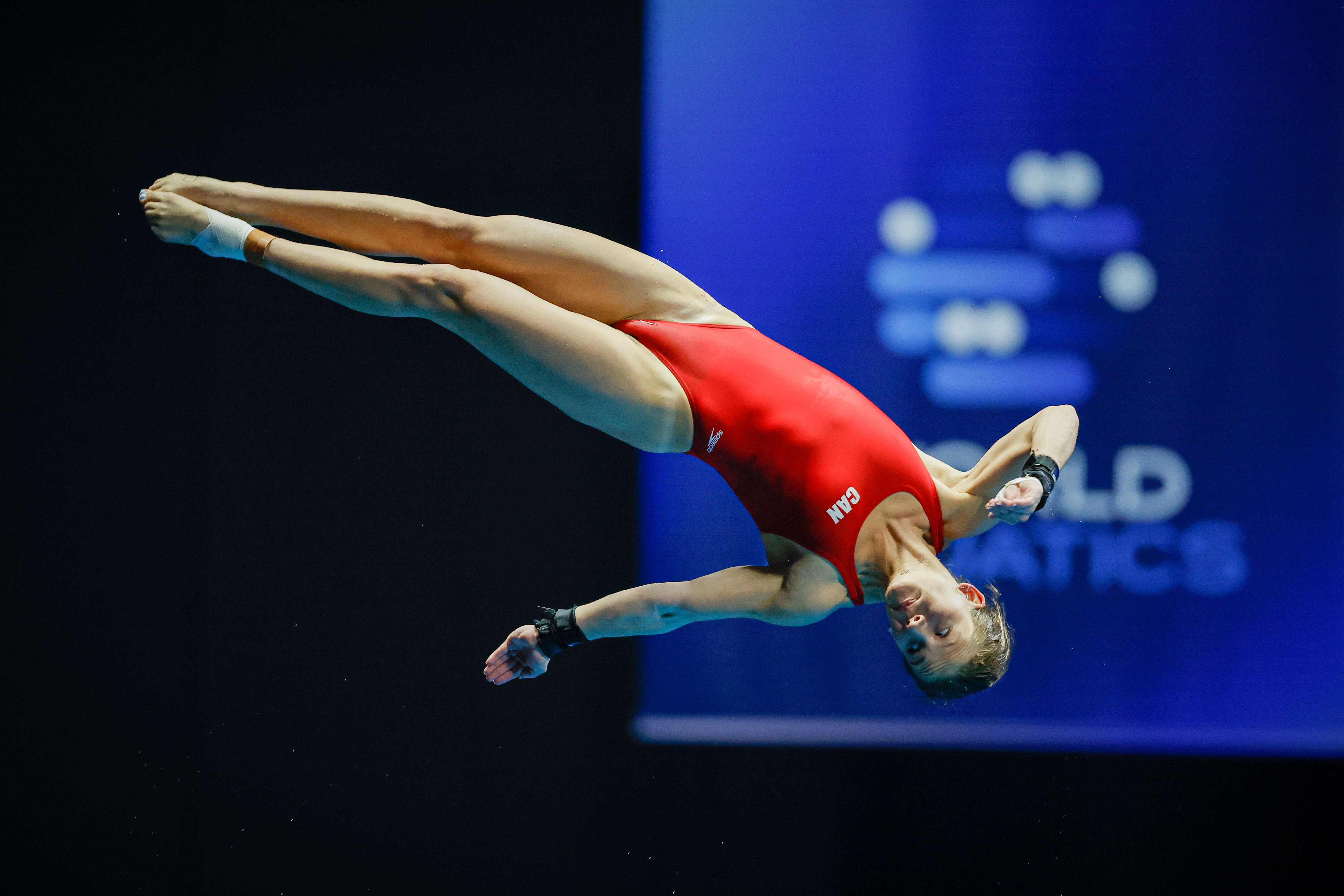 Caeli McKay dives off the 10m platform in layout position