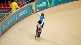 James Hedgcock waves to the crowd from his bike