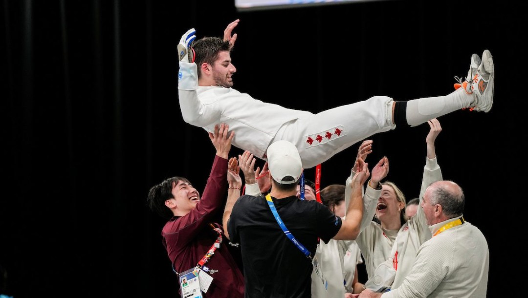 Dylan French is hoisted into the air by his teammates