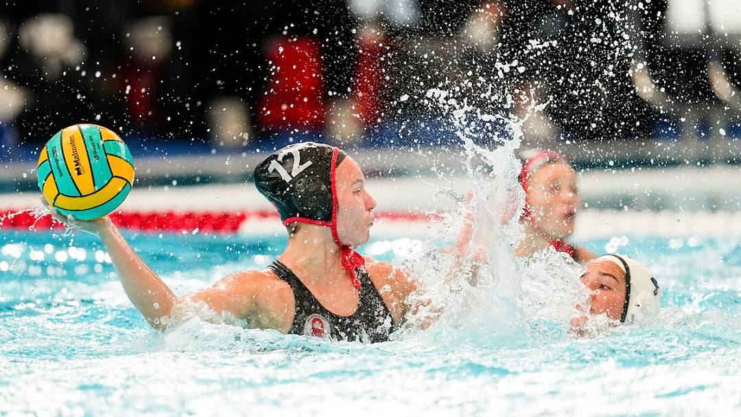 Floranne Carroll throws the ball while fending off an opponent