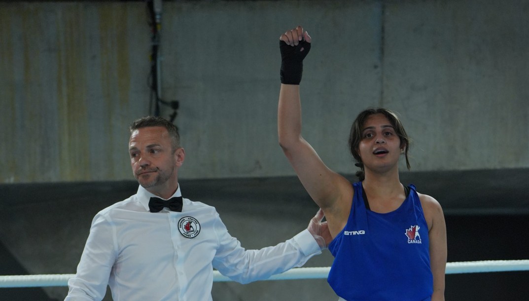 Garinder Takar raises her hands in victory