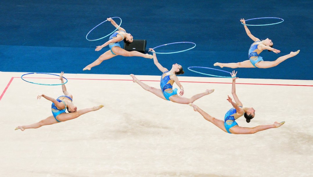 Rhythmic gymnasts perform with hoops