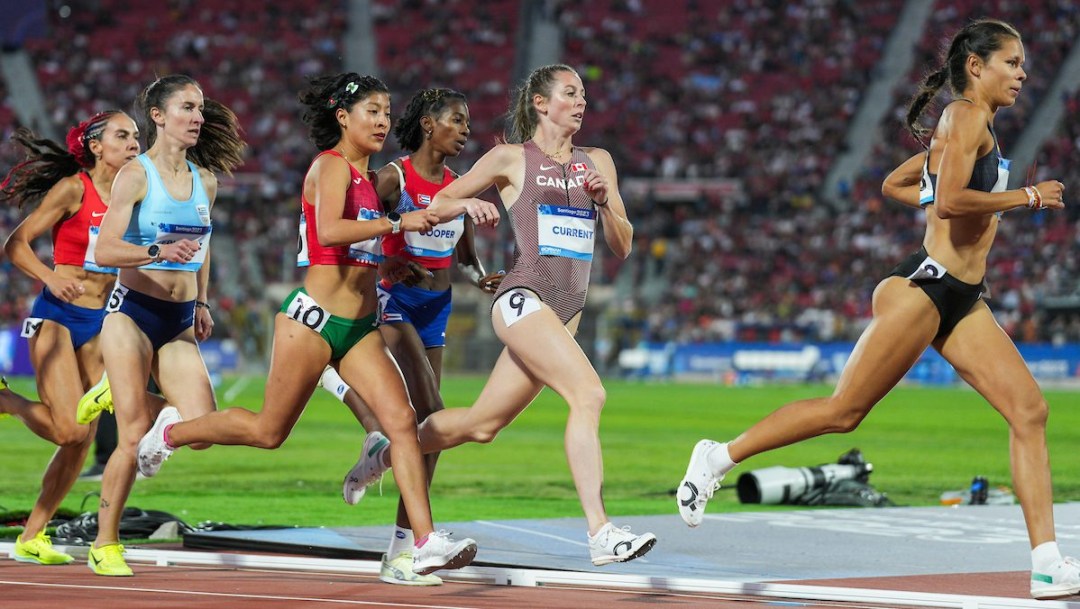 Kate Current runs with a pack of athletes on the track