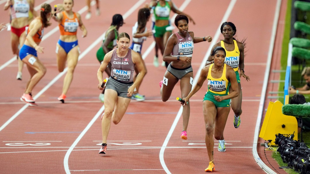 Grace Konrad runs with the baton