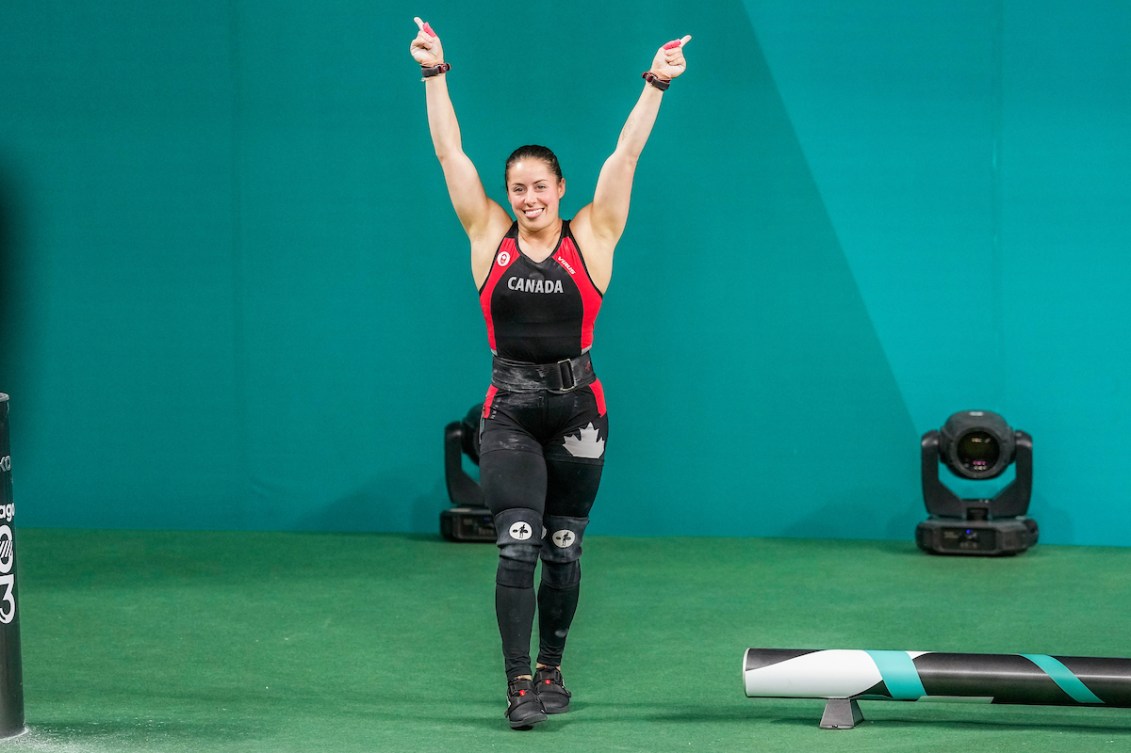 Maude Charron raises her arms in the air in celebration