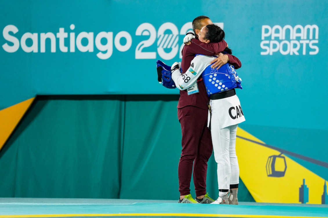 Skylar Park hugs her dad after winning the gold medal in the Women's Kyorugi 57kg during the Santiago 2023 Pan American Games