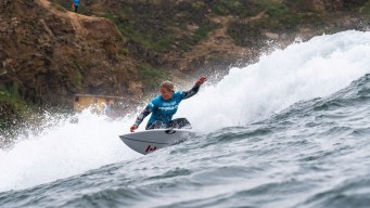 Sanoa Dempfle-Olin surfs a wave