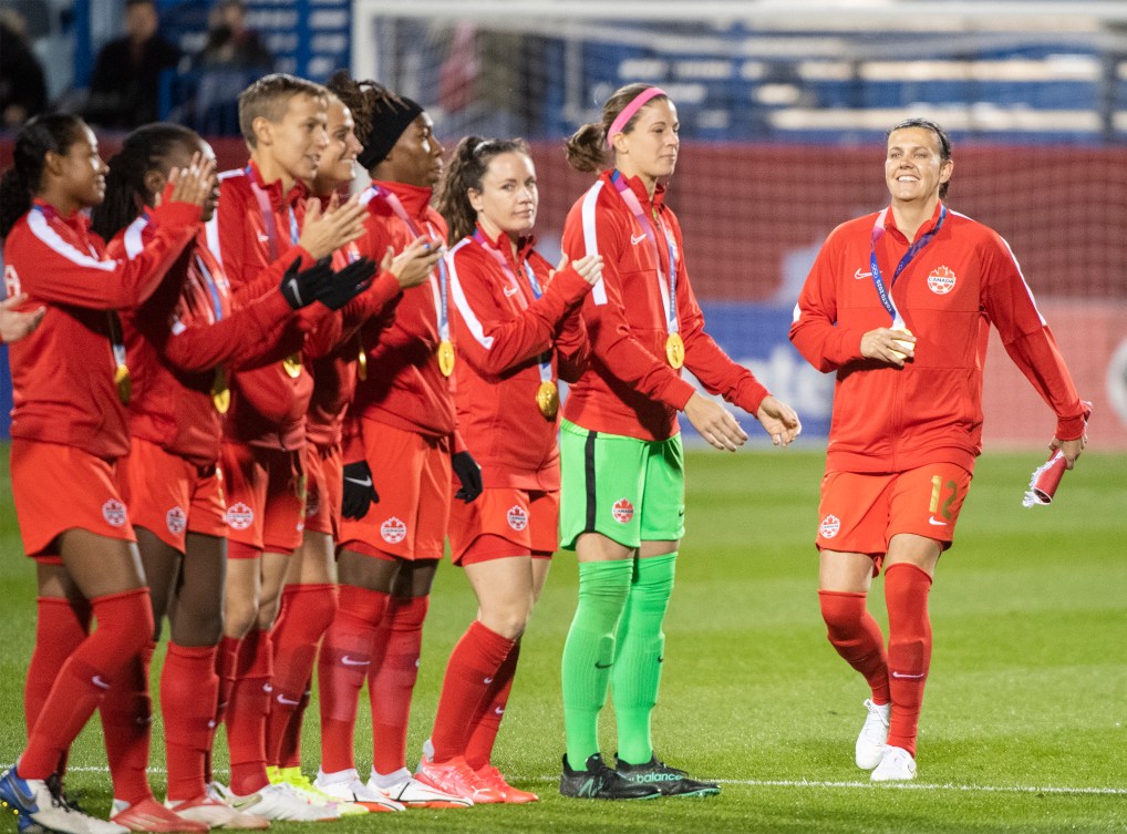 Canada’s Christine Sinclair, right, walks onto the pitch prior to their Celebration Tour soccer game against New Zealand in Montreal, Tuesday, October 26, 2021.