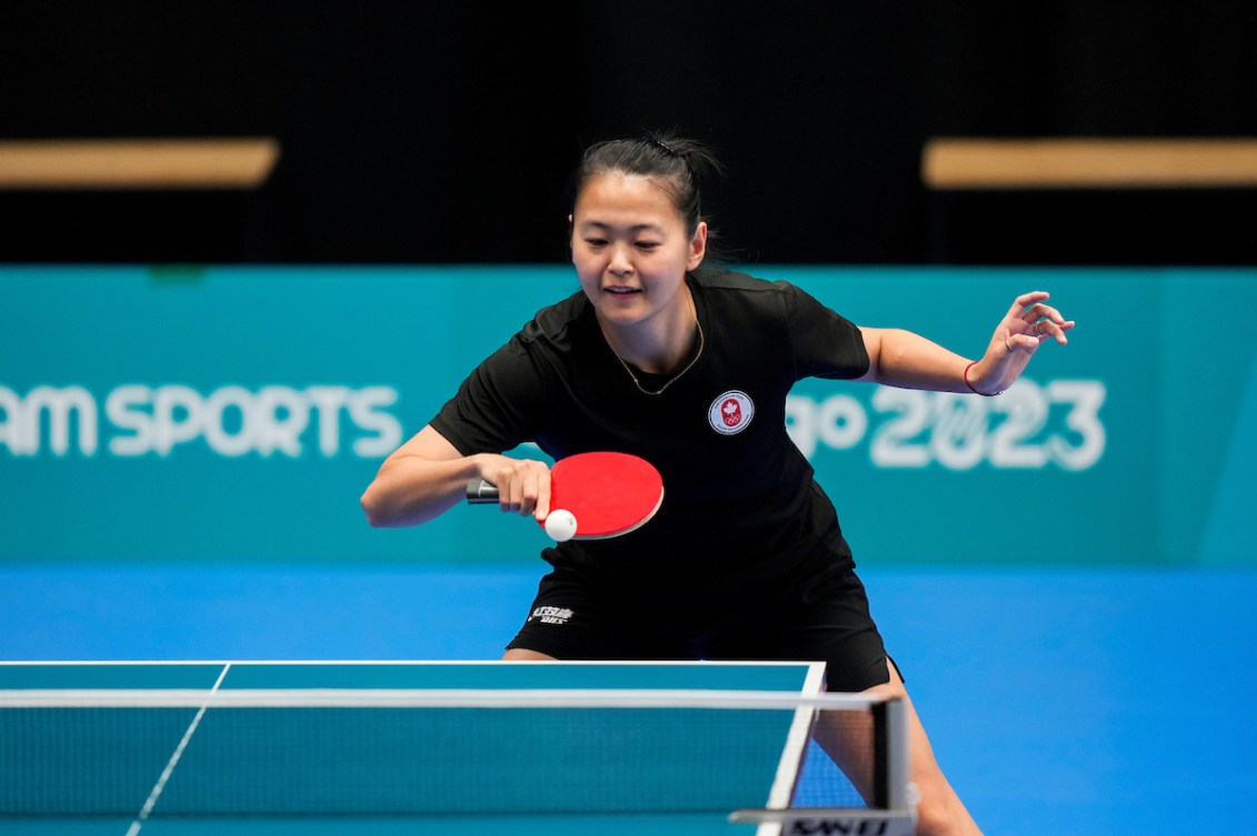 Mo Zhang about to hit the table tennis ball with her paddle