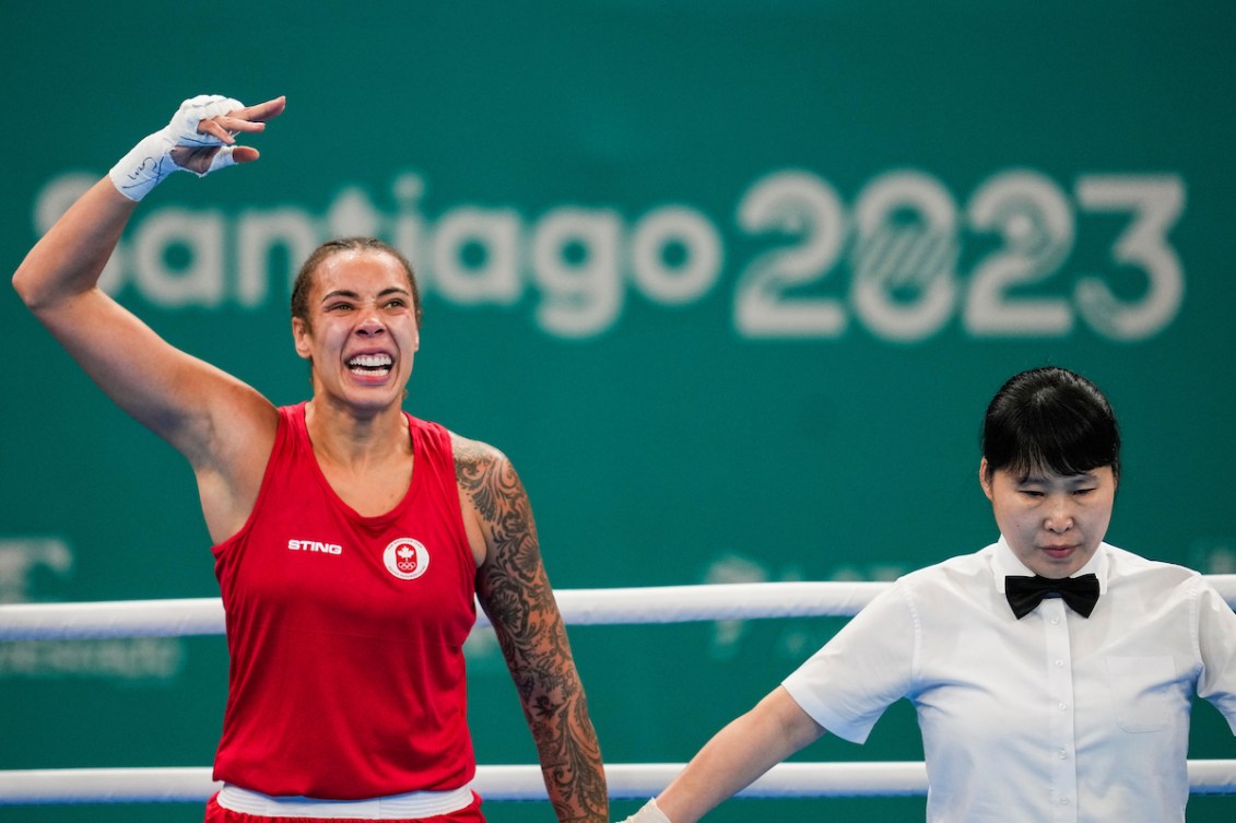 Tammara Thibeault has her arm in the air as the ref prepares to announce her as the winner